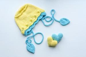 Beautiful baby knitted clothes and a toys for a newborn baby photo