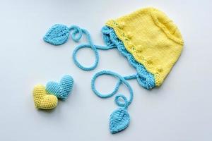 Beautiful baby knitted clothes and a toys for a newborn baby photo