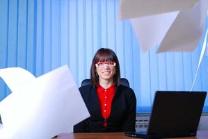 .happy businesswoman throwing papers in air photo