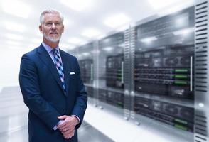 Senior businessman in server room photo