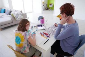 Mother and little daughter  playing together  drawing creative artwork photo