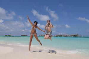 happy young couple have fun on beach photo