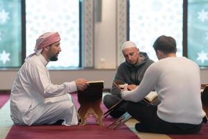 muslim people in mosque reading quran together photo