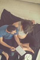 top view of couple checking a list of things for their unborn baby photo