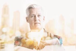 Double exposure of senior businessman photo