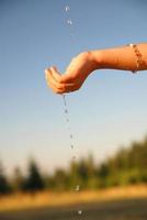 fresh water falling on children hands photo