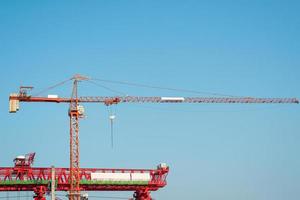 Crane and building construction work and blue sky photo