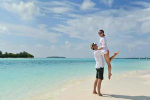 happy young couple have fun on beach photo