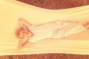 young woman resting on hammock photo