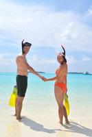 happy young couple have fun on beach photo