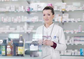 pharmacist chemist woman standing in pharmacy drugstore