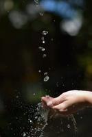 water stream on woman hand photo