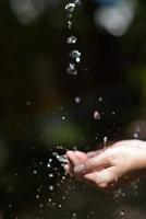 water stream on woman hand photo