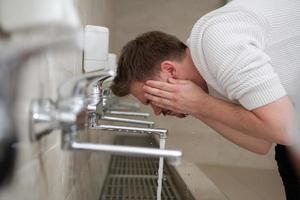 A Muslim takes ablution for prayer. Islamic religious rite photo