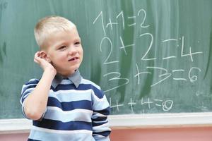 happy young boy at first grade math classes photo