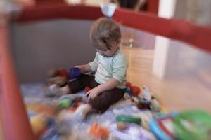 cute  little  baby playing in mobile  bed photo