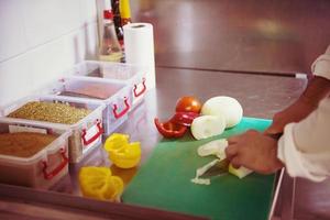 Chef hands cutting fresh and delicious vegetables photo