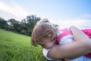 mother and little daughter playing at backyard photo