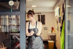 portrait of professional pet hairdresser hipster woman photo