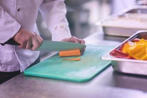 Chef hands cutting fresh and delicious vegetables photo