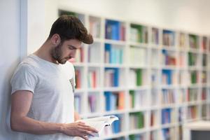 student in school library using tablet for research photo