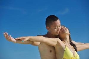 happy young  couple enjoying summer on beach photo