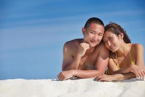 happy young  couple enjoying summer on beach photo