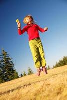 girl jumping outside photo