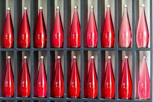 bottles of red juice in modern restaurant photo