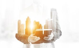 Double exposure of senior businessman with tablet photo