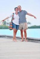 happy young couple have fun on beach photo