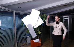 .happy businesswoman throwing documents photo