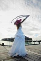 asian bride on beach photo