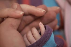 mother is playing with baby at home photo