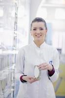 pharmacist chemist woman standing in pharmacy drugstore photo