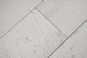 Ceramic wood effect tiles and tools for tiler on the floor photo