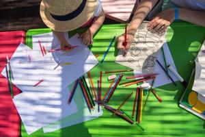 mom and little daughter drawing a colorful pictures photo