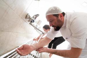 a group of Muslims take ablution for prayer. Islamic religious rite photo