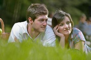 happy young couple having a picnic outdoor photo