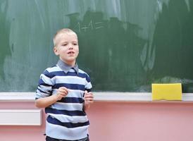 happy young boy at first grade math classes photo