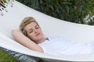 young woman resting on hammock photo