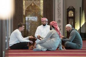 muslim people in mosque reading quran together photo