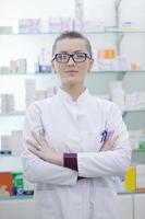 pharmacist chemist woman standing in pharmacy drugstore photo