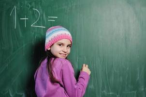 happy school girl on math classes photo