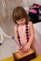 little girl painting jewelry box photo