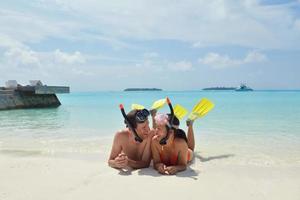 happy young couple have fun on beach photo