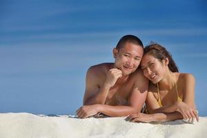 happy young  couple enjoying summer on beach photo