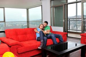 happy couple relax on red sofa photo