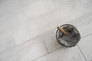 Ceramic wood effect tiles and tools for tiler on the floor photo