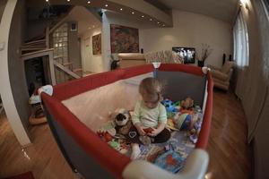cute  little  baby playing in mobile  bed photo